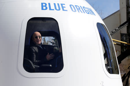 FILE PHOTO: Amazon and Blue Origin founder Jeff Bezos addresses the media about the New Shepard rocket booster and Crew Capsule mockup at the 33rd Space Symposium in Colorado Springs, Colorado, U.S., April 5, 2017. REUTERS/Isaiah J. Downing/File Photo