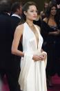 <p>Another Oscars red carpet, another plunging, backless halter look, this time with Angelina's silky dress with a matching shawl. </p>