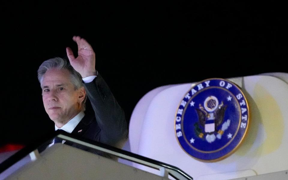 Antony Blinken, the US Secretary of State, waves as he arrives at Ben Gurion International airport in Tel Aviv, Israel