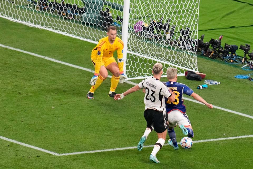 Japan's Takuma Asano, right, scores is side second goal during the World Cup group E football match between Germany and Japan, at the Khalifa International Stadium in Doha, Qatar, Wednesday, Nov. 23, 2022. (AP Photo/Ricardo Mazalan)