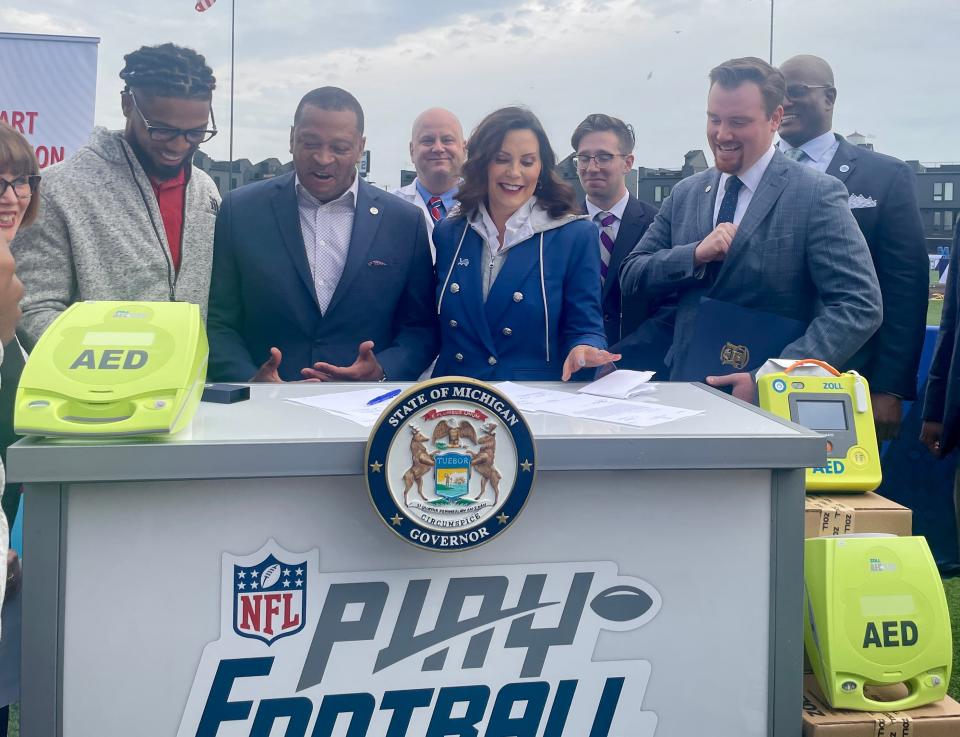 Damar Hamlin, Rep. Joe Tate, Gov. Gretchen Whitmer and Rep. John Fitzgerald sign House Bills 5527 and 5528 into act, requiring Michigan schools to develop more comprehensive cardiac emergency response plans on day 3 of the NFL draft in Detroit, on April 27, 2024.