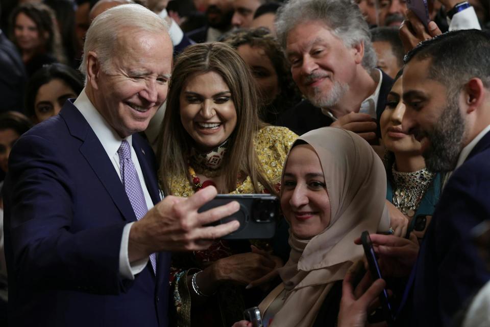 U.S. President Joe Biden, left, takes selfies on May 1, 2023, at the White House during a reception celebrating the end of Ramadan. <a href="https://www.gettyimages.com/detail/news-photo/president-joe-biden-takes-selfies-with-guests-during-a-news-photo/1486918953?adppopup=true" rel="nofollow noopener" target="_blank" data-ylk="slk:Alex Wong/Getty Images;elm:context_link;itc:0;sec:content-canvas" class="link ">Alex Wong/Getty Images</a>