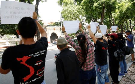 Anti-China protesters hold placards during a demonstration in front of the Chinese embassy in Hanoi