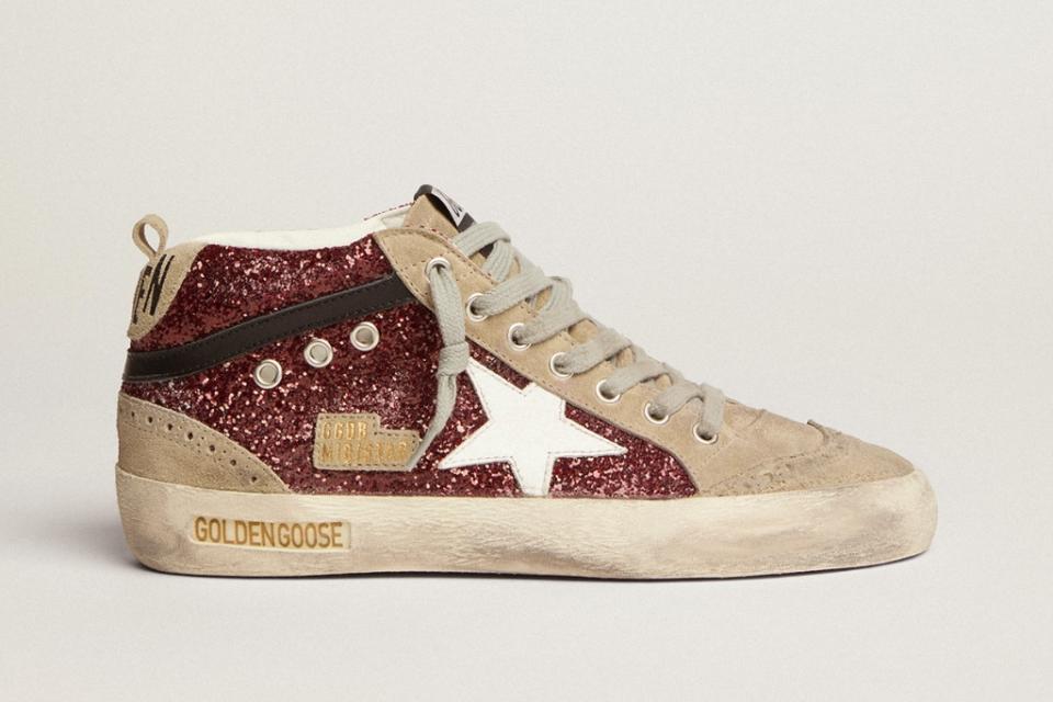 Mid Star sneakers in burgundy glitter with dove-gray suede inserts and white leather star. - Credit: Courtesy of Golden Goose