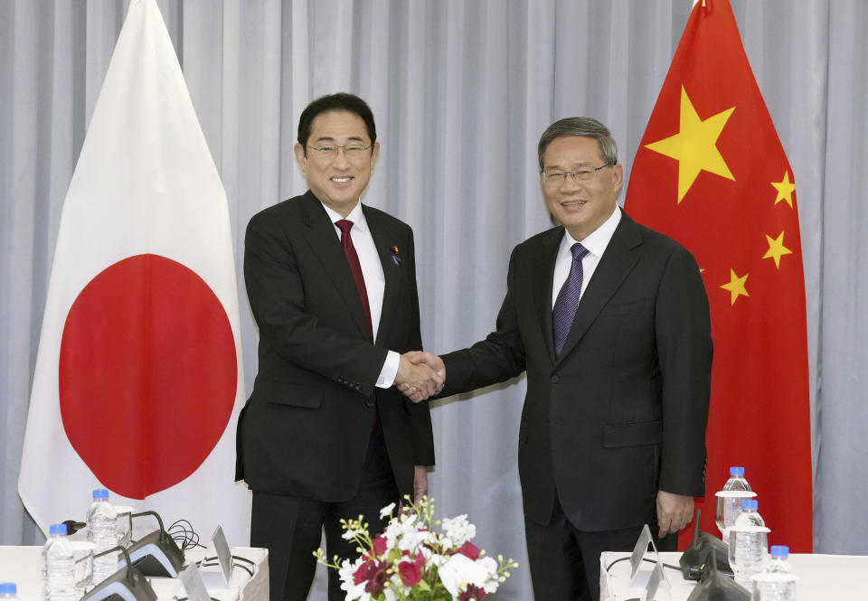 Japanese Prime Minister Fumio Kishida, left, shakes hands with Chinese Premier Li Qiang before their meeting in Seoul, South Korea, Sunday, May 26, 2024. (Daisuke Suzuki/Kyodo News via AP)