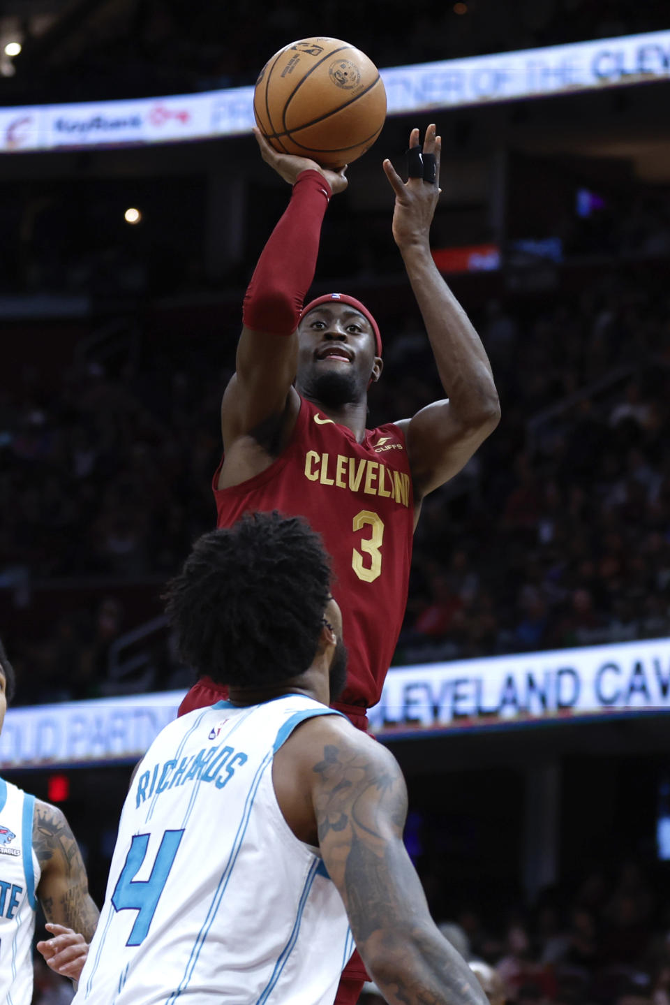 Cleveland Cavaliers guard Caris LeVert shoots against Charlotte Hornets center Nick Richards (4) during the first half of an NBA basketball game, Monday, March 25, 2024, in Cleveland. (AP Photo/Ron Schwane)