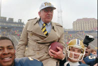 FILE - In this Nov. 30, 1996, file photo, University of Pittsburgh NCAA college football head coach Johnny Majors is carried off of the field by Justin Wade, left, and Nate Cochran, right, after beating Rutgers 24-9 in Major's last game as coach in Pittsburgh. Majors, the coach of Pittsburgh’s 1976 national championship team and a former coach and star player at Tennessee, has died. He was 85. Majors died Wednesday morning, June 3, 2020, at home in Knoxville, Tenn., according to a statement from his wife, Mary Lynn Majors. (AP Photo/Keith Srakocic, File)