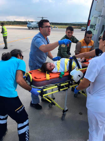 Medics carry a girl in a strecher after she survived from a sunken migrant boat, in Kandira, Turkey, September 22, 2017. Turkish Military/Handout via REUTERS