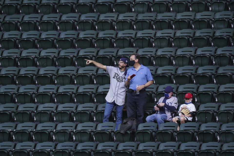 Fans watch batting practice before Game 1 of the baseball World Series between the Los Angeles Dodgers and the Tampa Bay Rays Tuesday, Oct. 20, 2020, in Arlington, Texas. (AP Photo/Eric Gay)