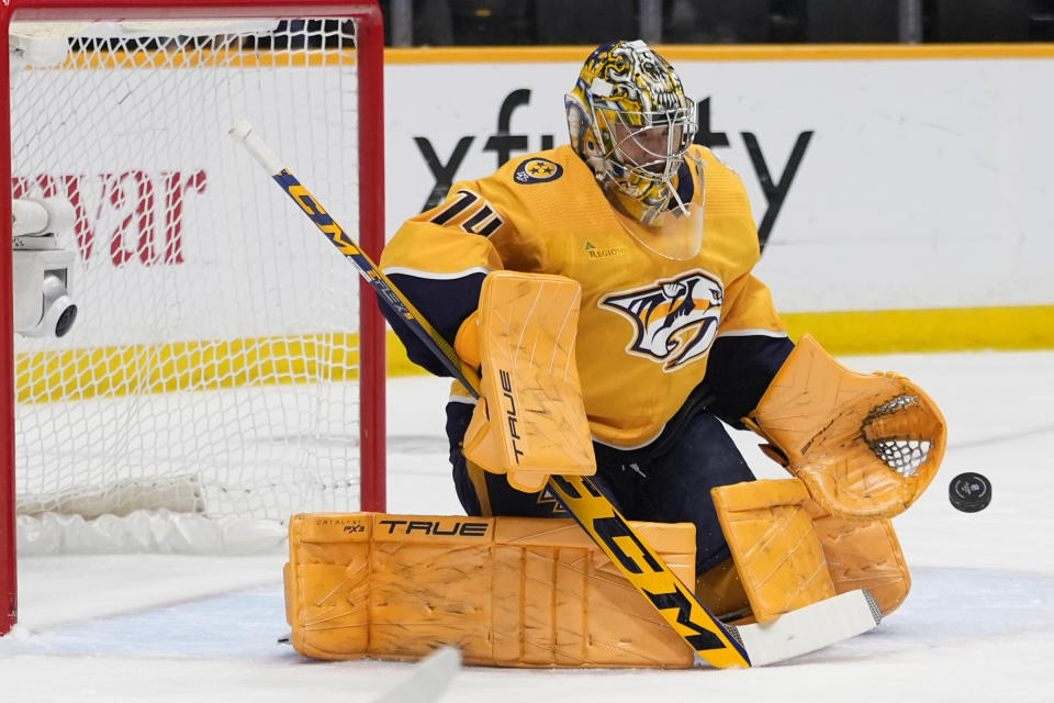 Nashville Predators goaltender Juuse Saros (74) blocks a shot on goal during the first period of an NHL hockey game against the Los Angeles Kings, Wednesday, Jan. 31, 2024, in Nashville, Tenn. (AP Photo/George Walker IV)