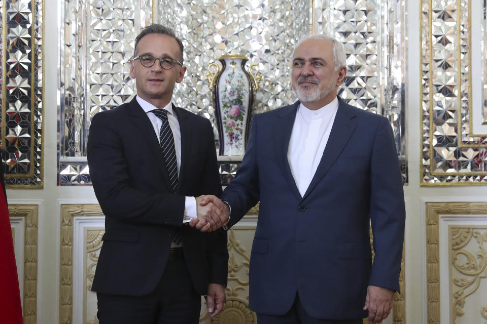 Iranian Foreign Minister Mohammad Javad Zarif, right, and his German counterpart Heiko Maas shake hands for media prior to their meeting, in Tehran, Iran, Monday, June 10, 2019. (AP Photo/Ebrahim Noroozi)