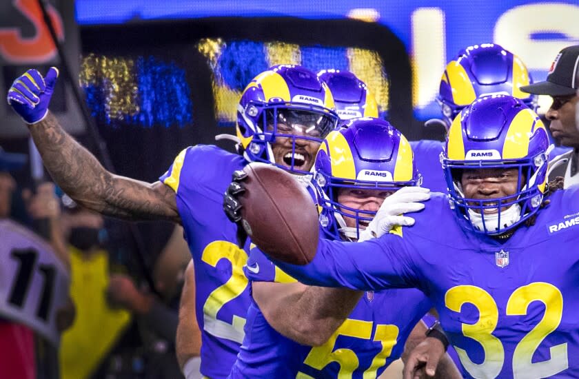 Travin Howard (32) celebrates with Rams teammates after his interception clinched the NFC championship.