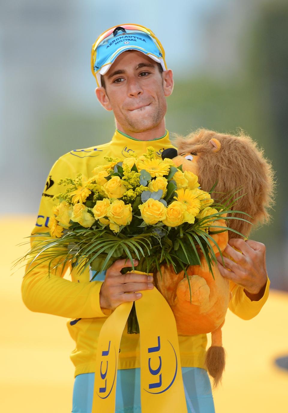 Race winner Vincenzo Nibali of Italy, wearing the overall leader's yellow jersey, celebrates on the podium of the Tour de France in Paris, France, Sunday, July 27, 2014. (AP Photo/Jerome Prevost, Pool)