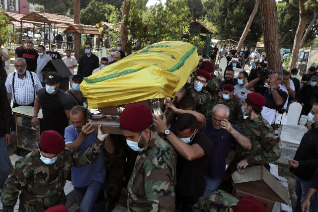 Hezbollah fighters carry the coffin of Ali Atwa, a senior Hezbollah operative, during his funeral procession in the southern Beirut suburb of Dahiyeh, Lebanon, Saturday, Oct. 9, 2021. Atwa was placed on the FBI's most wanted list in 2001, with two other alleged participants in the 1985 hijacking of TWA Flight 847, one of the worst hijackings in aviation history and that lasted for 16 days. (AP Photo/Bilal Hussein)