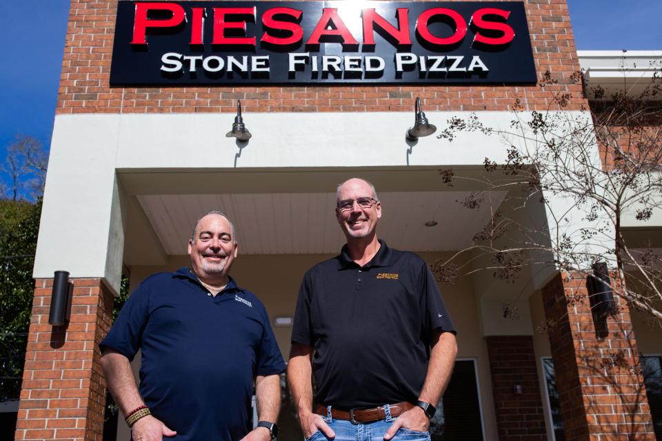 Owners of Piesanos Stone Fired Pizza, Joel Mills and Jerry Roberts pose for a portrait in front of the new Tallahassee location on Blairstone Road, Friday, Jan. 19, 2024.