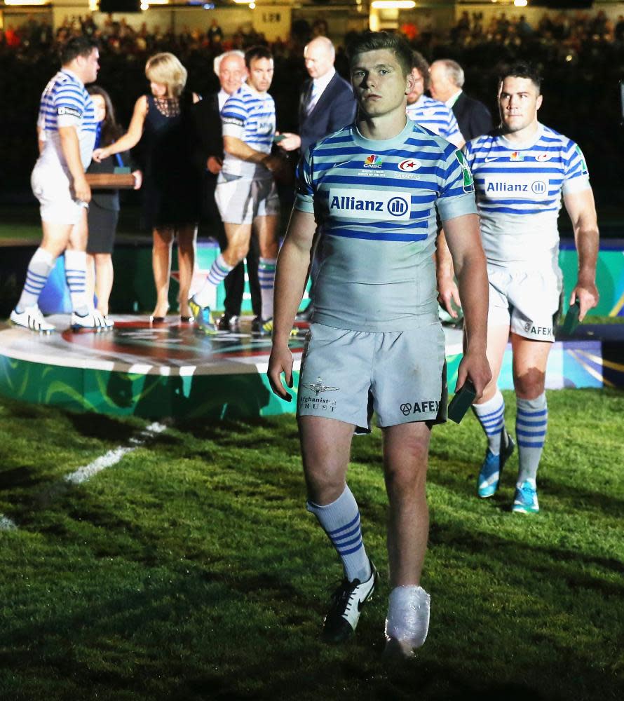 Owen Farrell walks off the pitch with his injured left ankle in an ice bag after Saracens defeat in the Heineken Cup final against Toulon in 2014