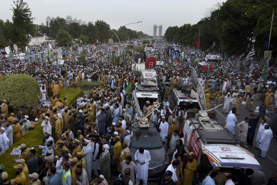 Supporters of Pakistan Democratic Movement, an alliance of the ruling political parties, attend a rally outside the Supreme Court, top left in Islamabad, Pakistan, Monday, May 15, 2023. Thousands of Pakistani government supporters converged on the country's Supreme Court, in a rare challenge to the nation's judiciary. Protesters demanded the resignation of the chief justice over ordering the release of former Prime Minister Imran Khan. (AP Photo/Ghulam Farid)