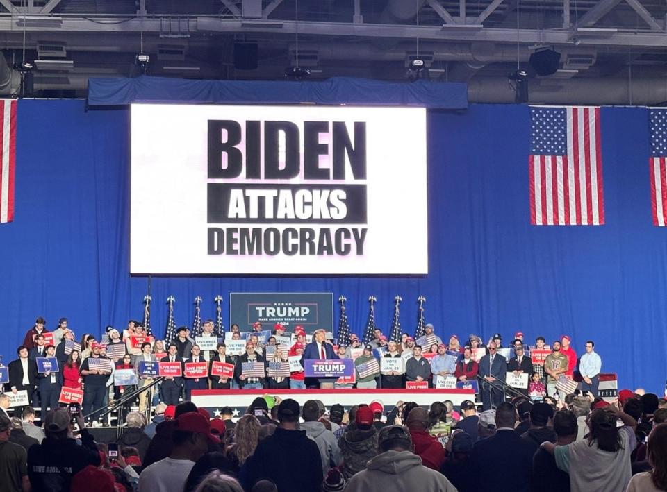 PHOTO: Former President Donald Trump speaks to supporters with a 'Biden Attacks Democracy' sign behind him, in Durham, New Hampshire, on Dec. 16, 2023. (Lalee Ibssa/ABC News)