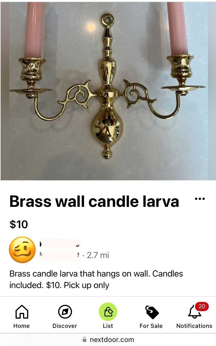 Brass wall-mounted candle holder with pink candles, advertised for $10 as "brass candle larva that hangs on wall"