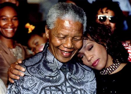 South African President Nelson Mandela (L) and U.S. pop star Whitney Houston pose for photographers at the presidency in Pretoria, in this file picture taken November 10, 1994. REUTERS/Juda Ngwenya/Files