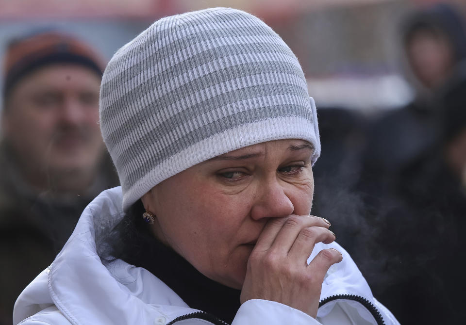 A woman reacts during prayers at the scene of the collapsed apartment building in Magnitogorsk, a city of 400,000 people, about 1,400 kilometers (870 miles) southeast of Moscow, Russia, Wednesday, Jan. 2, 2019. The building's pre-dawn collapse on Monday came after an explosion that was believed to have been caused by a gas leak. (AP Photo/Maxim Shmakov)