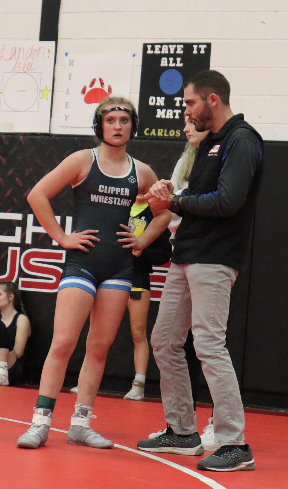 Clear Creek Amana coach Adam Endres speaks with freshman wrestler Brenna Williams during the Highland Tournament.