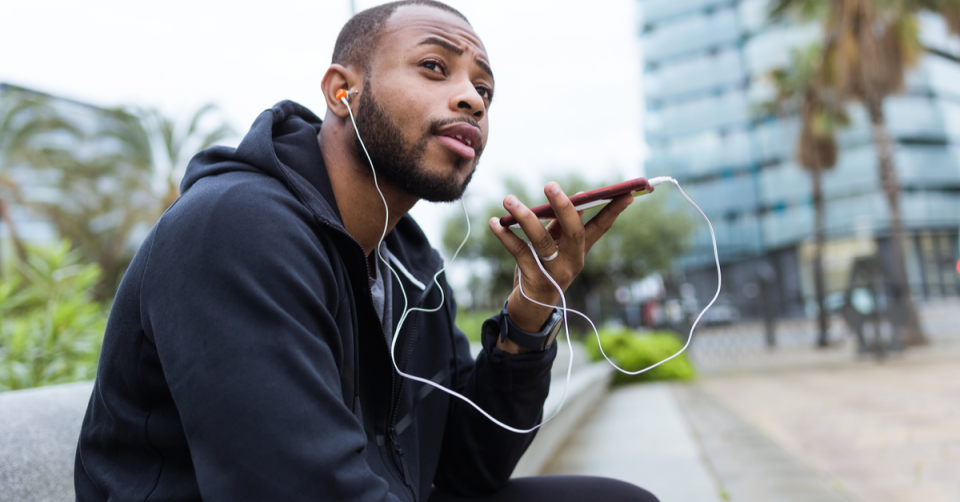 a may who is exercising outside and practicing social distancing is making a phone call to his employer to ask about his 401k options