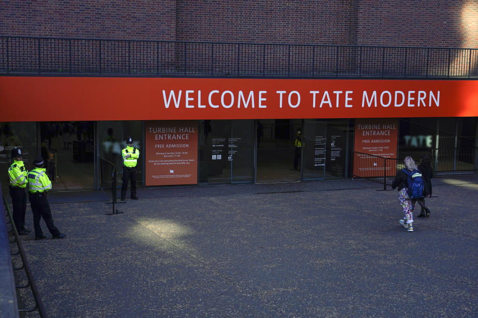 FILE - Police officers patrol the entrance of Tate Modern gallery, in London, Saturday, Oct. 15, 2022. The U.K. Supreme Court ruled on Wednesday, Feb. 1, 2023, that a viewing platform at London’s Tate Modern art gallery made residents of glass-walled luxury apartments next door feel like animals in a zoo, and impeded “the ordinary use and enjoyment” of their homes. (AP Photo/Alberto Pezzali, File)