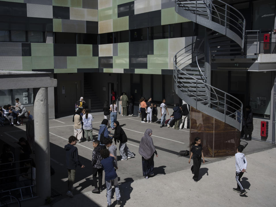 Students spend time in the courtyard during recess at Ibn Khaldoun, a private Muslim school, in Marseille, southern France, Tuesday, April 16, 2024. (AP Photo/Daniel Cole)