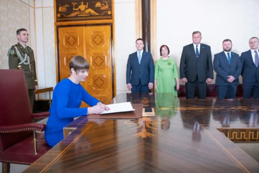 Estonian President Kersti Kaljulaid signs documents reappointing Juri Ratas (Background L) as Prime Minister