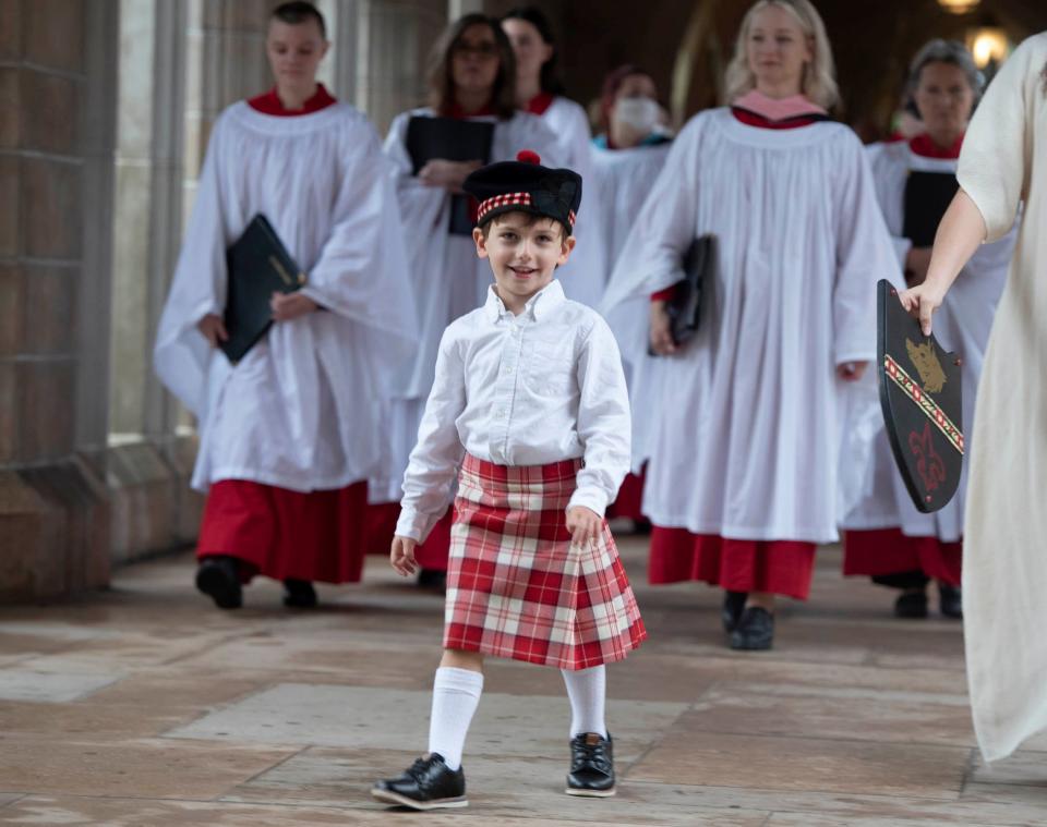 Arms bearer John Rieger, 4, prepares to perform in the 2024 Boar's Head and Yule Log Festival on Saturday.