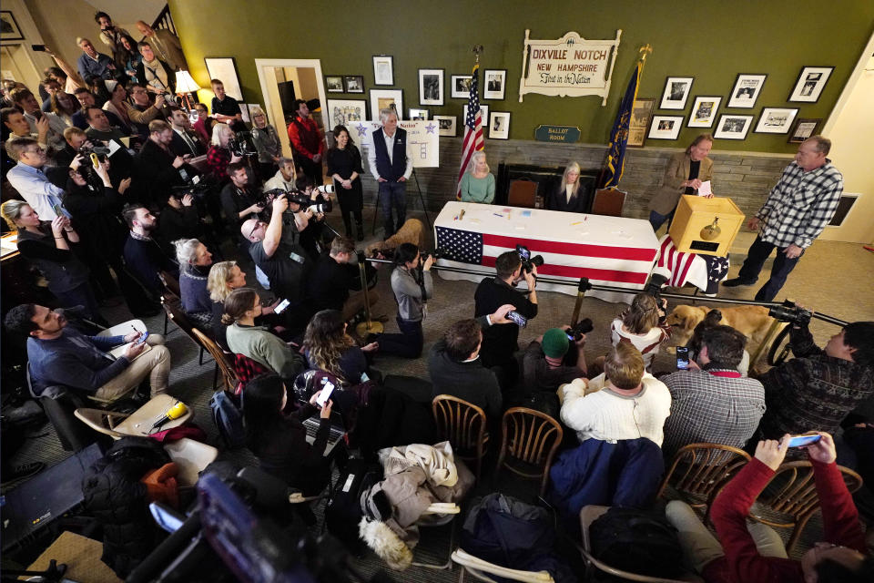 A large crowd of media and spectators watch as town moderator Tom Tillotson inserts Scott Maxwell's ballot shortly after midnight in the presidential primary election, Tuesday, Jan. 23, 2024, in Dixville Notch, N.H. (AP Photo/Robert F. Bukaty)