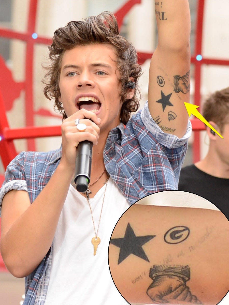 A yellow arrow pointing to a tattoo on Harry Styles that reads "won't stop 'till we surrender"