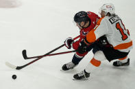 Washington Capitals defenseman Dmitry Orlov (9) and Philadelphia Flyers right wing Travis Konecny (11) go for the puck during the third period of an NHL hockey game, Friday, May 7, 2021, in Washington. The Flyers won 4-2. (AP Photo/Alex Brandon)