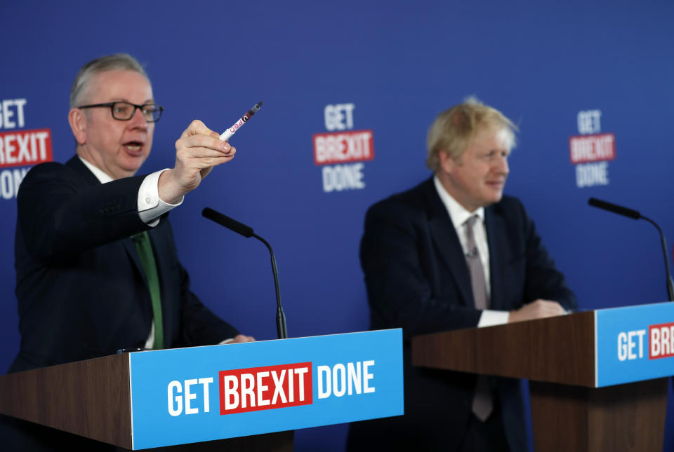 Chancellor of the Duchy of Lancaster Michael Gove, left, and Britain's Prime Minister Boris Johnson attend a media conference in London, Friday, Nov. 29, 2019. Britain goes to the polls on Dec. 12. (AP Photo/Frank Augstein)