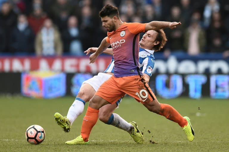 Huddersfield's Dean Whitehead (R) vies with Manchester City's Sergio Aguero during their English FA Cup fifth round football match on February 18, 2017