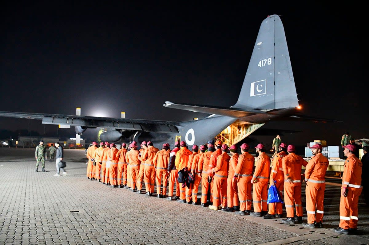 Pakistan Army’s Urban Search and Rescue team members board a plane for the departure to Turkey to help rescue operation in earthquake hit areas, at Nur Khan airbase in Rawalpindi, Pakistan (AP)