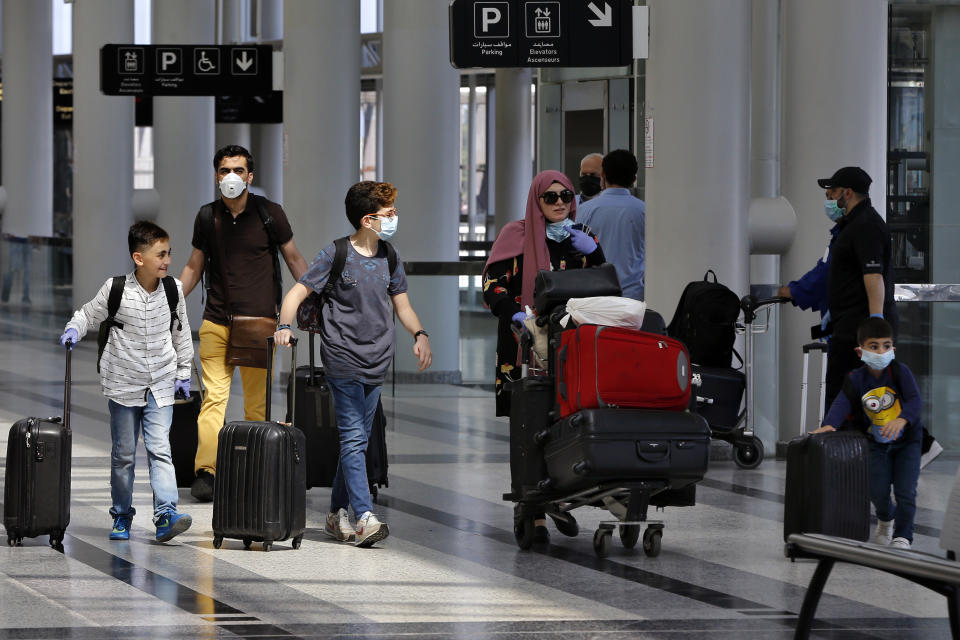 FILE - Travelers push their luggage at the departure terminal of the Rafik Hariri International Airport in Beirut, Lebanon, Wednesday, July 1, 2020. Lebanon's caretaker transportation minister on Thursday, March 30, 2023 said a contract for a new terminal at the country's main airport is cancelled, following criticism that no public bidding was held for the $122 million project. (AP Photo/Bilal Hussein, File)