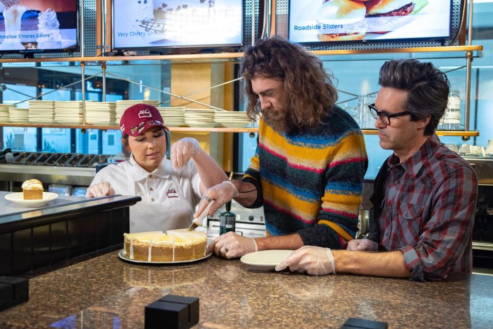 Hosts Charles "Link" Neal and Rhett McLaughlin work with Cheesecake Factory employee PJ Starr, as seen on Inside Eats with Rhett and Link, Season 1.