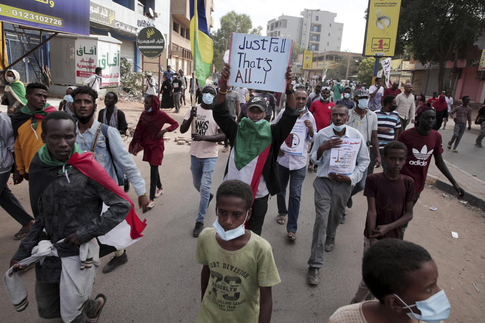 People march during a protest to denounce the October military coup, in Khartoum, Sudan, Saturday, Dec. 25, 2021. Sudanese security forces fired tear gas to disperse protesters as thousands rallied since earlier in the day, even as authorities tightened security across Khartoum, deploying troops and closing all bridges over the Nile River linking the capital with its twin city of Omdurman and the district of Bahri, the state-run SUNA news agency reported.(AP Photo/Marwan Ali)