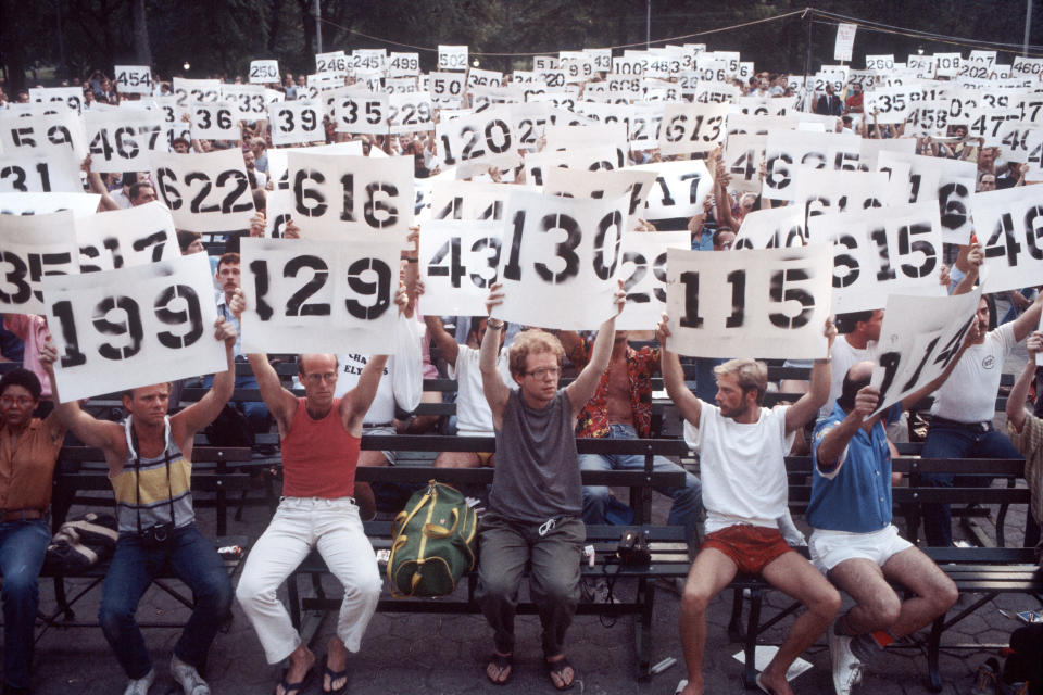 Image: People hold up signs representing the numbers of AIDS victims in a demonstration in support of AIDS victims in Central Park in New York City on Aug. 8, 1983. (Allan Tannenbaum / Getty Images file)