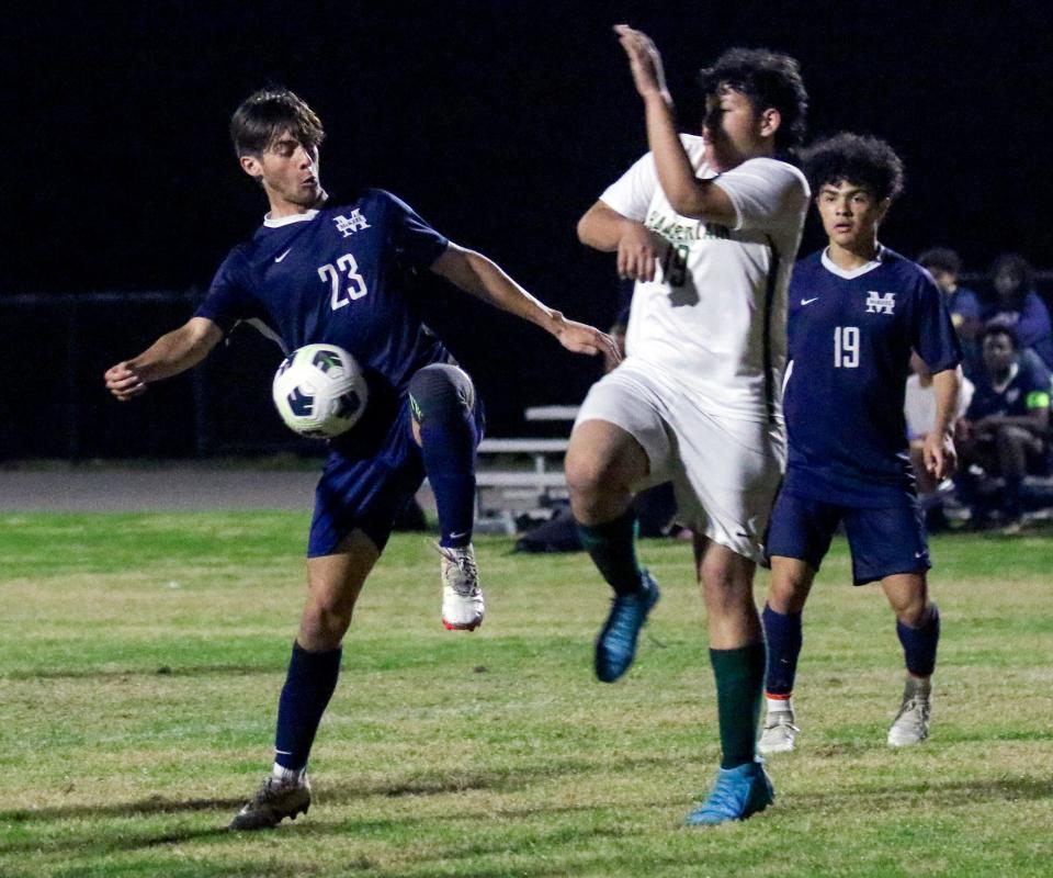 McKeel's Nathan Erickson battles for control of the ball in the second half on Monday night in the Class 4A, District 10 boys soccer tournament.