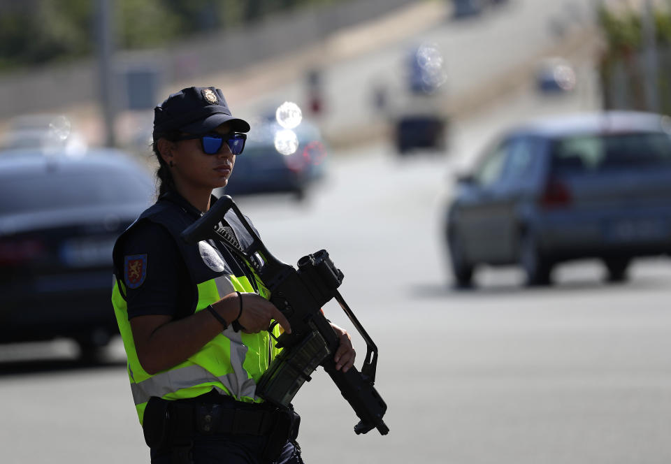 Spanish and French police officers stand guard at the border between Hendaye and Irun to monitor protestors against the G-7 summit in nearby Biarritz, France Friday, Aug. 23, 2019. (AP Photo/Emilio Morenatti)