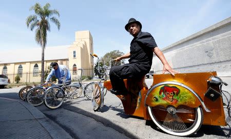 Manny Silva sits on a low rider bicycle he customized, outside his bike shop in Compton, California U.S., June 3, 2016. Picture taken June 3, 2016. REUTERS/Mario Anzuoni