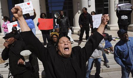 Bobby Worthy, CEO/President of The Justice League, leads a chant outside of the Duval County Courthouse as jury deliberations enter the fourth day during the trial of Michael Dunn in Jacksonville, Florida February 15, 2014. REUTERS/Kelly Jordan/Florida Times-Union/Pool