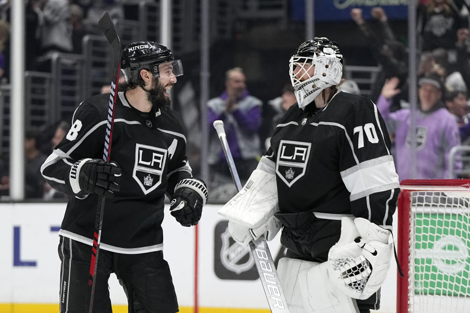 Los Angeles Kings defenseman Drew Doughty, left, celebrates with goaltender Joonas Korpisalo after left wing Kevin Fiala scored an empty net goal during the third period of an NHL hockey game against the St. Louis Blues Saturday, March 4, 2023, in Los Angeles. (AP Photo/Mark J. Terrill)