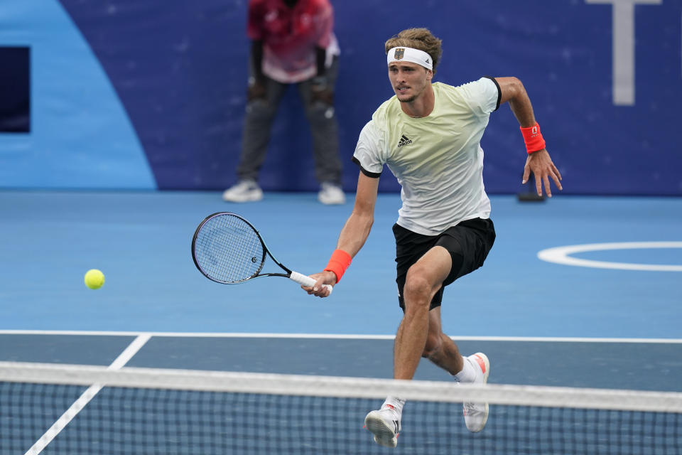 Alexander Zverev, of Germany, returns to Novak Djokovic, of Serbia, during the semifinal round of the men's tennis competition at the 2020 Summer Olympics, Friday, July 30, 2021, in Tokyo, Japan. (AP Photo/Patrick Semansky)