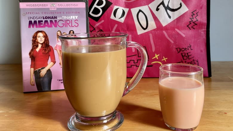 Two cups in front of Mean Girls DVD case