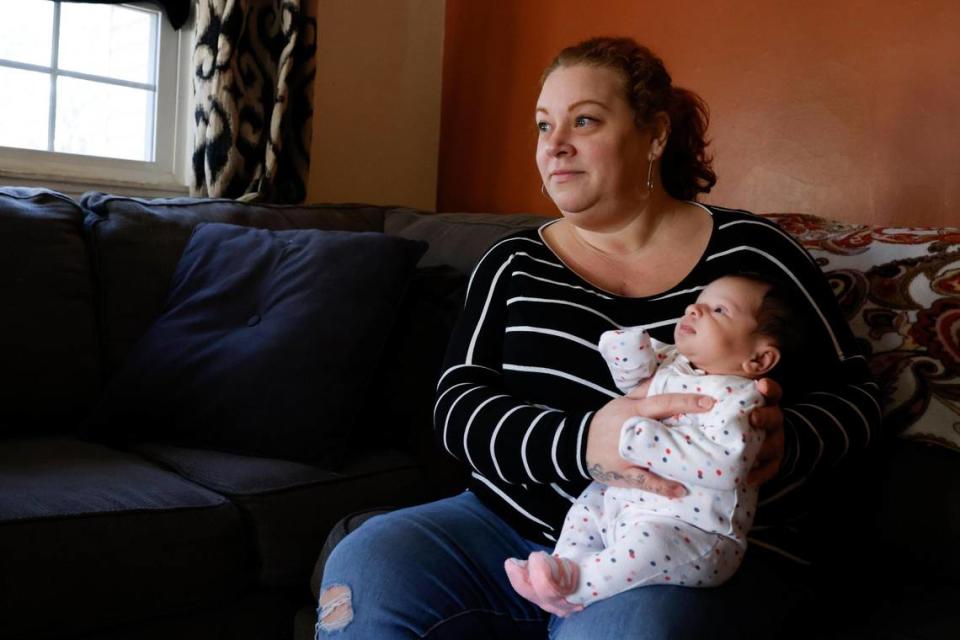 Erin O’Malley, of Charlotte, N.C., holds her newborn daughter, Lennox O’Malley, in their home in Charlotte., Monday, Nov. 14, 2022. O’Malley visited the doctor with pain from a hernia and was surprised to find out she was 39-40 weeks pregnant. As a teenager, O’Malley was told she was unable to have children due to a hormone condition called Polycystic ovary syndrome.