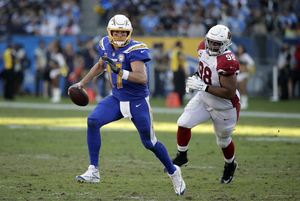 Los Angeles Chargers quarterback Philip Rivers (17) is chased by Arizona Cardinals defensive tackle Corey Peters during the second half of an NFL football game Sunday, Nov. 25, 2018, in Carson, Calif. (AP Photo/Jae C. Hong )